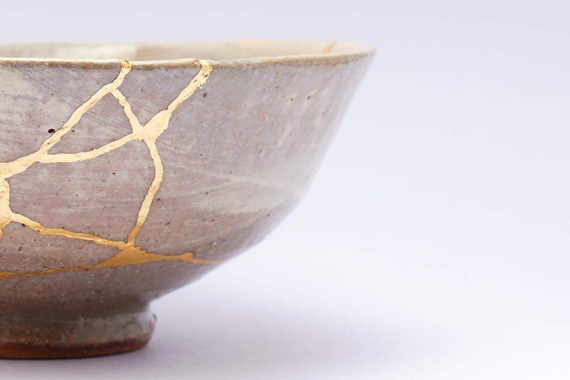 A Japanese bowl mended with gold in the kintsugi tradition — a picture of restoration